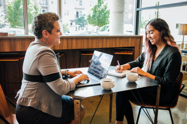 woman leading a meeting while wearing She Rex strap